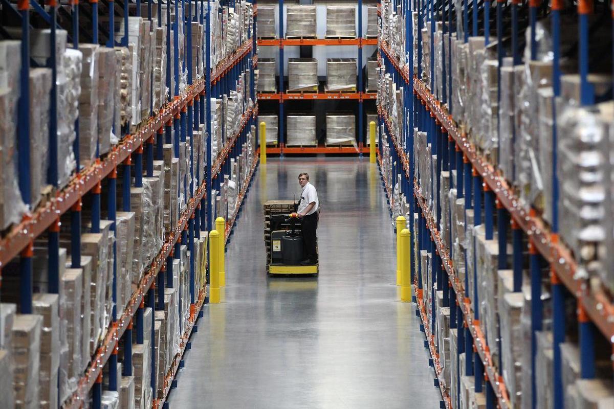 driving hi-lo in warehouse with racking