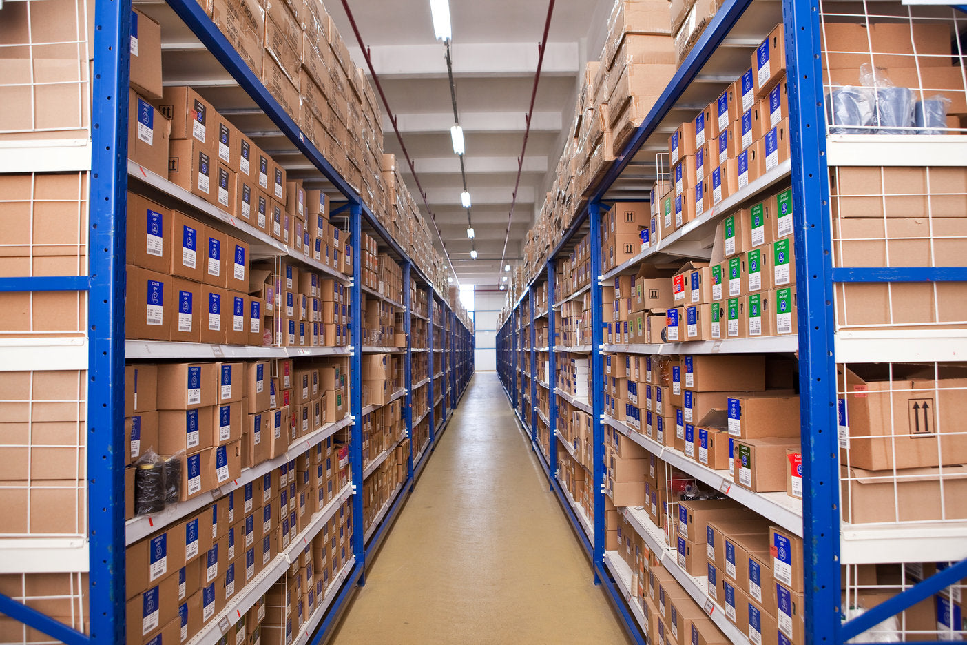 Warehouse with boxes on shelves receding