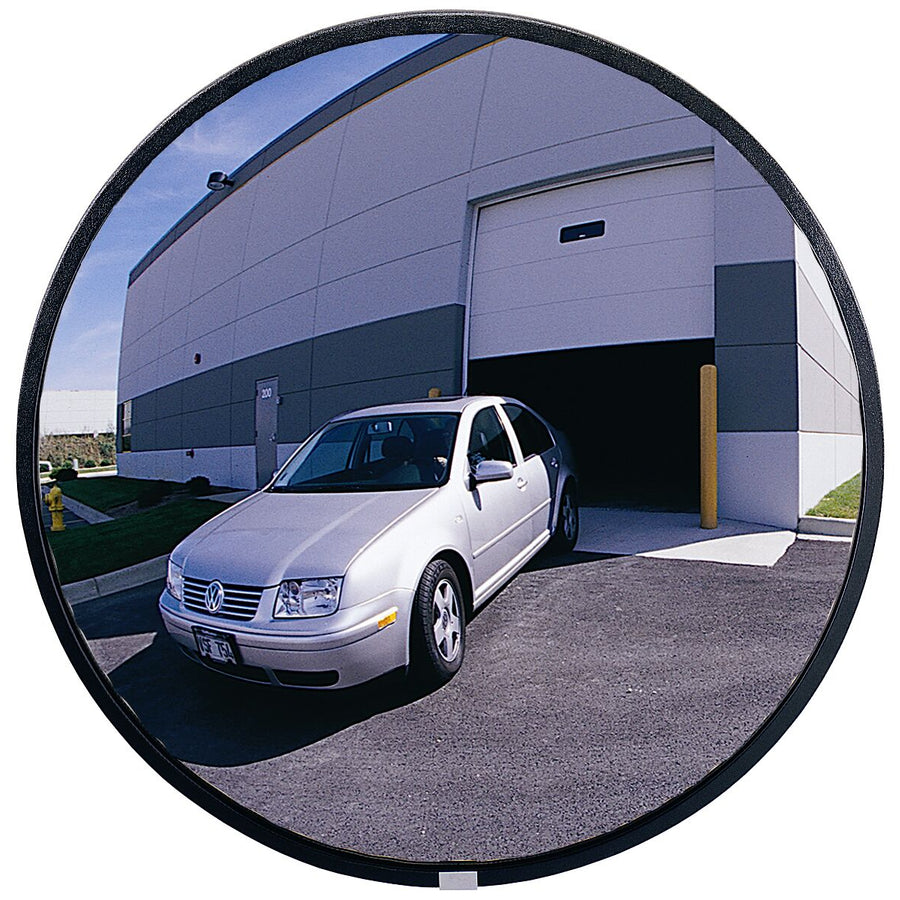 Car exiting a building through a wide-angle round mirror