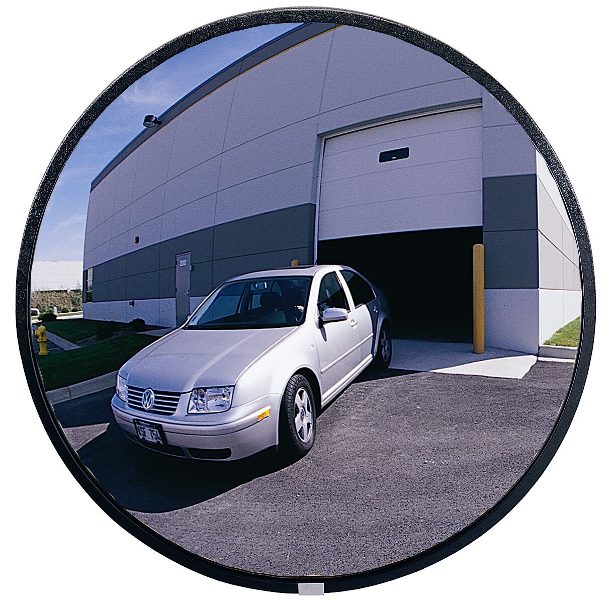 Car exiting a building through a wide-angle round mirror