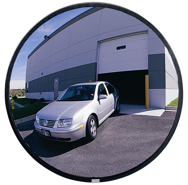 Car exiting a building through a wide-angle round mirror